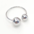 Close-up of a polished silver titanium steel open bangle with smooth spherical ends - Double Sphere Open Ring (R6056)