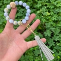 Detail view of marble pattern beads and grey leather tassel on a stylish keychain bracelet - Grey PU Tassel Marble Gold Foil Beaded (款15)