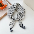 Detailed view of polka dot cotton linen scarf with black tassels on white surface - Black and White Polka Dots (Fringe)