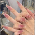 Close-up of glossy pink gradient press-on nails with long coffin shape and glitter finish - By2221 / Phototherapy Glue Style