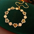 Macro shot of 18K gold plated heart tiger eye stone and sunburst charm adjustable bracelet - Gold Heart Tiger Eye Style