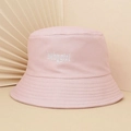 Detailed close-up of pink bucket hat with white babygirl script embroidery on cotton fabric - One Size / Pink