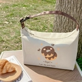 Insulated beige canvas lunch bag with donut print and adjustable brown handle strap - Bagel