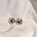 Detailed close-up of spherical silver stud earrings on soft cream satin fabric - 18# Silver Minimalist Spherical Style (18# Ear Clip-Silver)