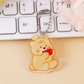 Cute yellow acrylic bear keychain with crown and apple on a silver ball chain - Apple Eating Bear