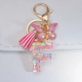 Pink resin letter F keychain with butterfly sequins, pink tassel and golden lobster clasp - Letter F
