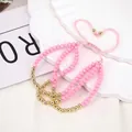 Detailed close-up of pink faceted beads with adjustable braided cord bracelets for women - One Size / Pink