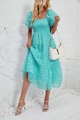 Detail of teal summer tiered dress featuring puff sleeves and smocked bodice texture - Cyan