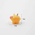 Detail view of a 18mm x 20mm cartoon pig pendant made of translucent orange resin material - Pig