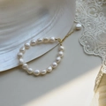 French Baroque freshwater pearl bracelet with gold adjustable clasp on white shell background - Style 1