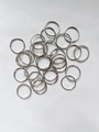 Flat lay of multiple minimalist silver geometric rings in various patterns on white background - Minimalist Twenty Ring Collection (J225) / Silver