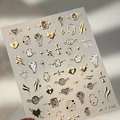 Luxurious gold foil nail stickers with melting clocks and starburst designs, style M-1240 - Golden Melting Clock Style (M-1240)