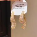 Close-up of 925 silver bow earrings with baguette-cut zircons and gold plating - 925 Sterling Silver Earring Post - Gold Streamlined Teardrop