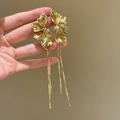 Gold metal flower earrings with tassel fringe and sparkling crystals on hand - Gold