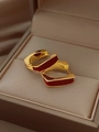 Macro shot of U-shaped gold earrings with deep red enamel glaze on jewelry box - EH-374-Claret Enamel