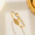 Golden titanium steel double butterfly bangle with sparkling pavé cubic zirconia - Gold