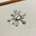 Detailed view of silver liquid splash brooch on minimalist fabric background - 40 Silver Fireworks (Z-4113)