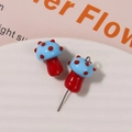 Close-up of blue and red glass mushroom pendants for DIY jewelry making accessories - No.6 (Blue Cap Red Dot Red Stem)