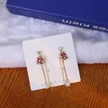 Detail view of asymmetric Christmas drop earrings with red enamel gift box and pearls - Gift Box & Pearl Tassel Style