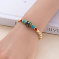 Gros plan d'un bracelet de perles bohème tissé avec charme de moulin à prières tibétain au poignet - Toujours avec Toi