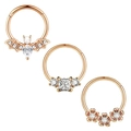 Detailed macro view of 3-piece rose gold nose rings with bat, floral, and gem designs - 1.2x8mm / Rose Gold Bat Square Rhinestone Flower Style (Set 10)