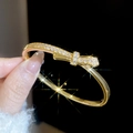Detailed view of 18k gold plated bracelet featuring a sparkling zircon bow design - Gold (Bow Knot Full Drill)