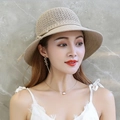 Detail of a beige woven straw sun hat with ribbon tie and summer fashion accessories - Hollow Lace-up Khaki