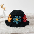 Close-up of handmade black crochet bucket hat with colorful 3D knitted flower patterns - One Size / Multicolor Daisy Black Base