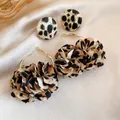 Detail view of leopard print fabric flower hoop earrings and round button studs set - 2-Piece Set (Leopard Flower Hoop + Round Button)