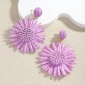 Handmade raffia flower drop earrings in vibrant purple with woven texture detail - Purple Sunflower Woven Earrings