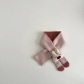 Detail of pink knitted baby scarf with 3D bunny head and cross-through design - Scarf / Pink