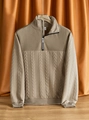 Detail of a beige knit sweatshirt showing intricate cable patterns and zipper collar - S / Khaki