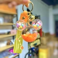 Detail of Mickey-shaped liquid keychain with orange sequins and macaron beads - Orange Luminous Snowflake Mickey Head