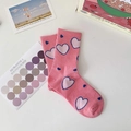 Cute pink crew socks featuring white heart patterns and ribbed cuffs on white background - One Size / Heart Pattern / Pink