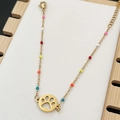 Bohemian gold chain bracelet featuring colorful beads and a hollowed-out paw print pendant - Colorful