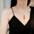 Titanium steel necklace with red white black clover pendants and tassel on model - Clover Tassel Style (532) / Black White Red
