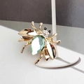 Elegant gold beetle brooch with a large faceted green drop-shaped gemstone - Light Green