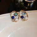 Detailed close-up of gold petal earrings with pearls, blue beads and zircon crystals - Gold Hollow Dark Blue Bead Iridescent Shell Zirconia (10#)