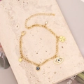Detalle de pulsera de acero dorado con estrella turquesa y dijes de ojo turco - Estilo Combo de Múltiples Dijes de Ojo del Mal y Estrella (6#)