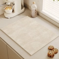 Creamy beige kitchen drying mat with non-slip geometric texture for countertop water absorption - Circular Waves