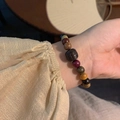 Multicolor wooden bead bracelet featuring natural grains and a carved central bead - Gold/Multicolor Wood Beads