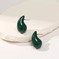 Detailed close-up of dark green teardrop stud earrings on a textured stone base - Dark Green