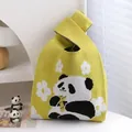 Yellow knitted wrist bag featuring a panda and white flower pattern with knot handle - Yellow Floral Panda