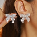 Sparkling crystal bow stud earrings with white rhinestones on silver base model view - Silver Pixel Style Rhinestone Bowknot Stud Earrings DTE1216411S-W