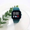 Deep green digital LED watch with octagonal case and astronaut icon on white ceramic tray - Dark Green