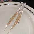Macro shot of long fringe rhinestone earrings with silver and gold dual-tone metal details - Gold