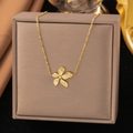 Elegant gold flower pendant necklace displayed on a gray square jewelry gift box - Five-petal Flower (AH346) / Gold