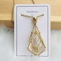 Golden mesh cage necklace featuring a teardrop-shaped clear crystal pendant - Gold Clear Quartz