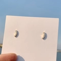 Minimalist gold curved bar earrings with sparkling cubic zirconia on a pink card - 925 Silver Needle / Gold Curved Stud Earrings