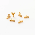 Close-up of polished gold-plated letter Y alphabet beads for DIY jewelry making - Letter Y / Gold